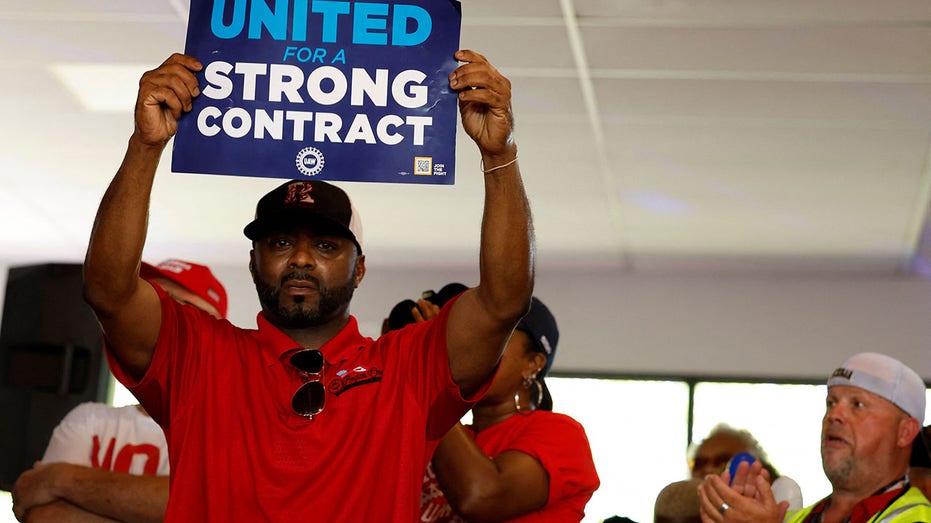 UAW member holds sign