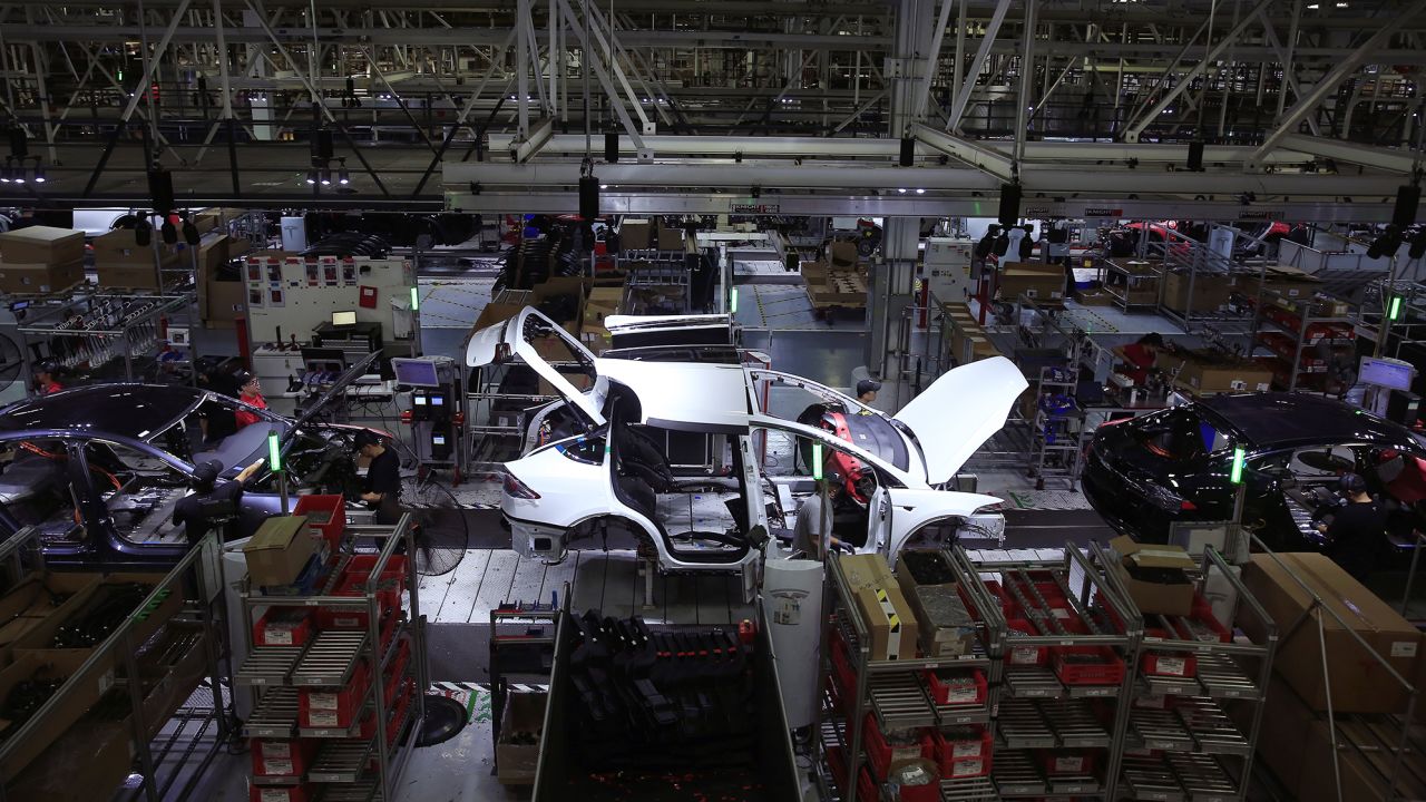 A Tesla Model X is worked on a factory line with Tesla X's and Tesla S's at the Tesla factory on Wednesday, July 18, 2018 in Fremont, Calif.