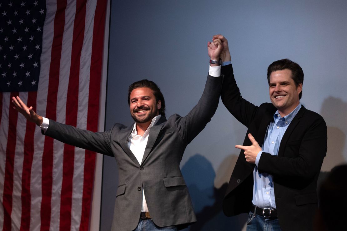 Florida Rep. Matt Gaetz raises Brandon Herrara's hand after both speak at a rally for Herrara at the Angry Elephant in San Antonio, Texas, on March 13.