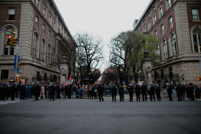 Police officers stand near barriers as pro-Palestinian protesters gather outside of Columbia on April 18.